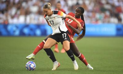 Canada midfielder Simi Owujo battles Klara Buhl of Germany.