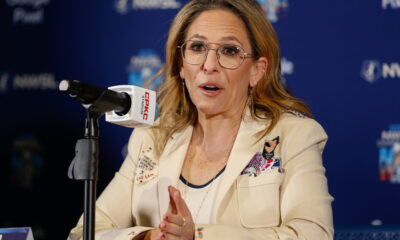 Jessica Berman speaks into a microphone at a press conference.