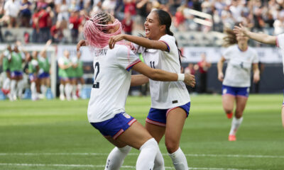 Photo of Tirnity Rodman and Alyssa Thompson embracing and celebrating a goal.