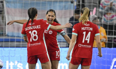 Lo'eau LaBonta celebrates with teammates Izzy Rodriguez and Claire Hutton in a match against the San Diego Wave in April 2025.