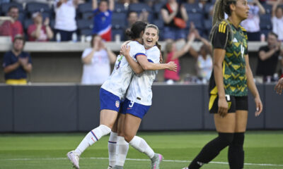 Ally Sentnor celebrates scoring a goal by hugging a teammate.