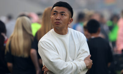 Masaki Hemmi wears a white sweater and looks on from the touchline during a Chicago Stars FC match on June 7.