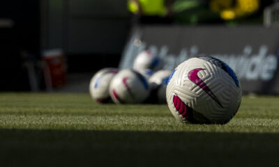 NWSL game balls sitting on the pitch in Kansas City. Photo is taken at ground level.