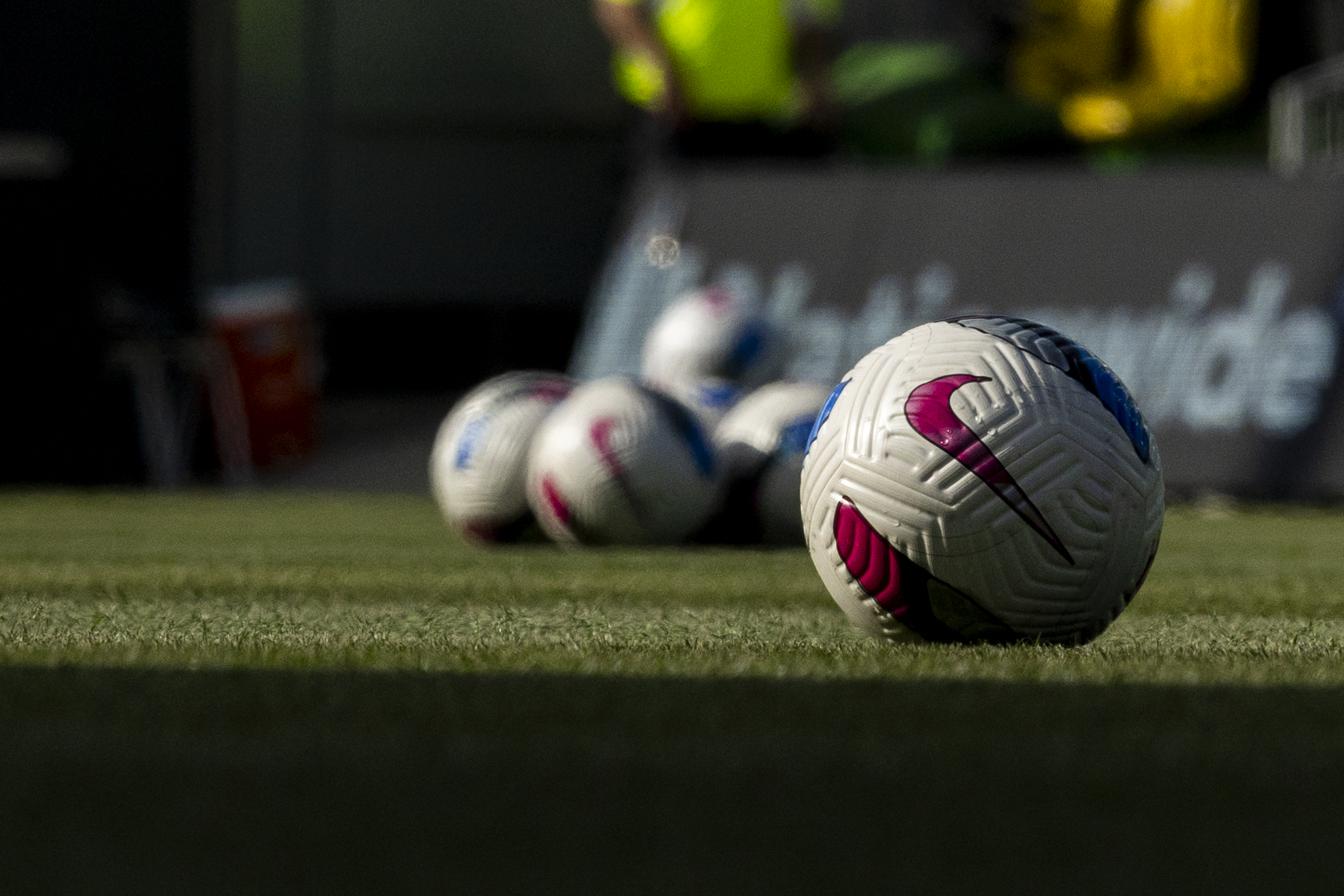 NWSL game balls sitting on the pitch in Kansas City. Photo is taken at ground level.