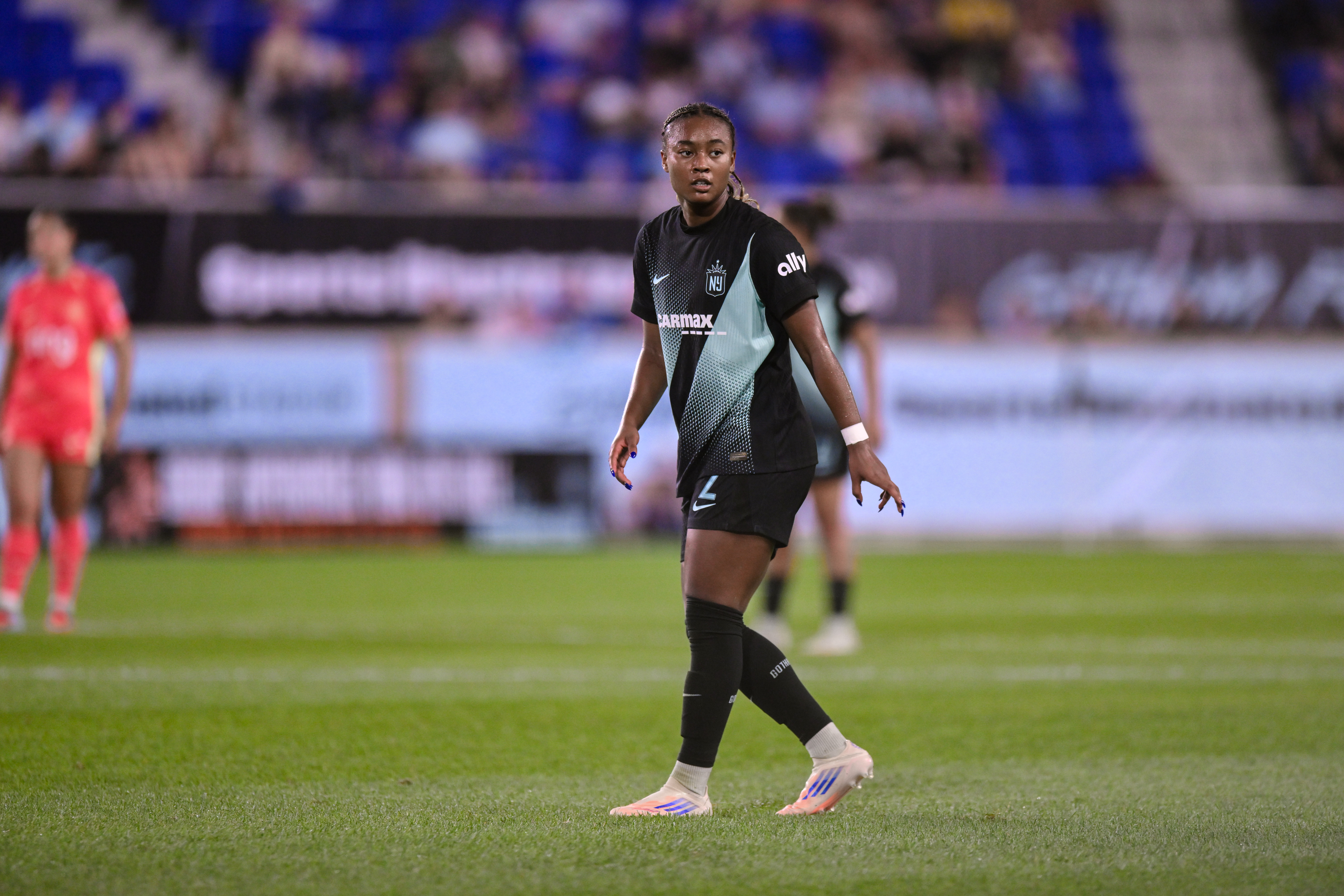 Jaedyn Shaw looks directly at the camera watching the play.